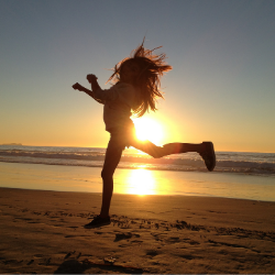 Woman jumping at beach