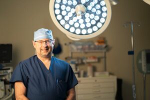 Dr. Kurt Eichholz in operating room with lights