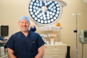 Dr. Robert A. Morgan in operating room with lights