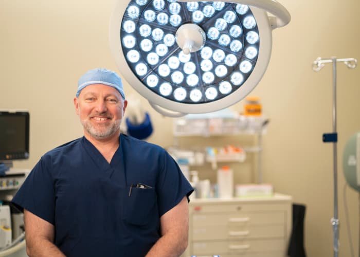 Dr. Robert A. Morgan in operating room with lights